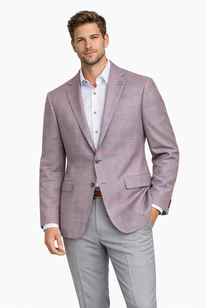A man wears the Byron Contemporary Sport Coat 6674A by Byron, in light purple plaid Italian fabric, paired with a white dress shirt and light gray trousers, standing against a plain white background in a modern fit.