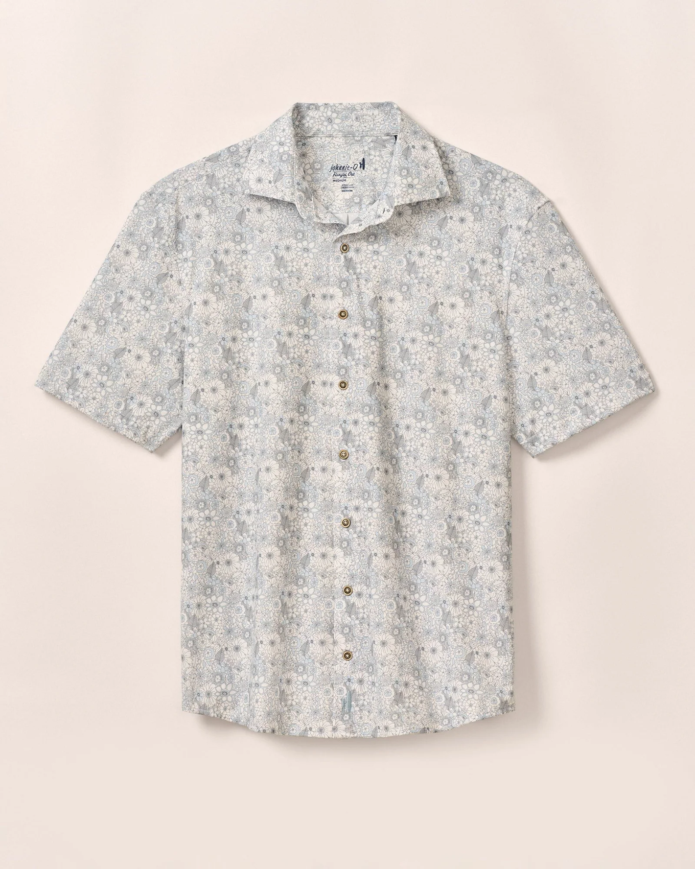 The Johnnie-O Kayce Big&Tall Short Sleeve shirt by Johnnie-O features light blue and white knit fabric with a small floral pattern and short sleeves, shown against a plain beige background.