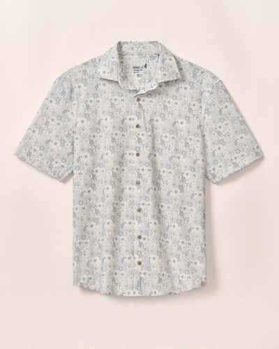 The Johnnie-O Kayce Big&Tall Short Sleeve shirt by Johnnie-O features light blue and white knit fabric with a small floral pattern and short sleeves, shown against a plain beige background.