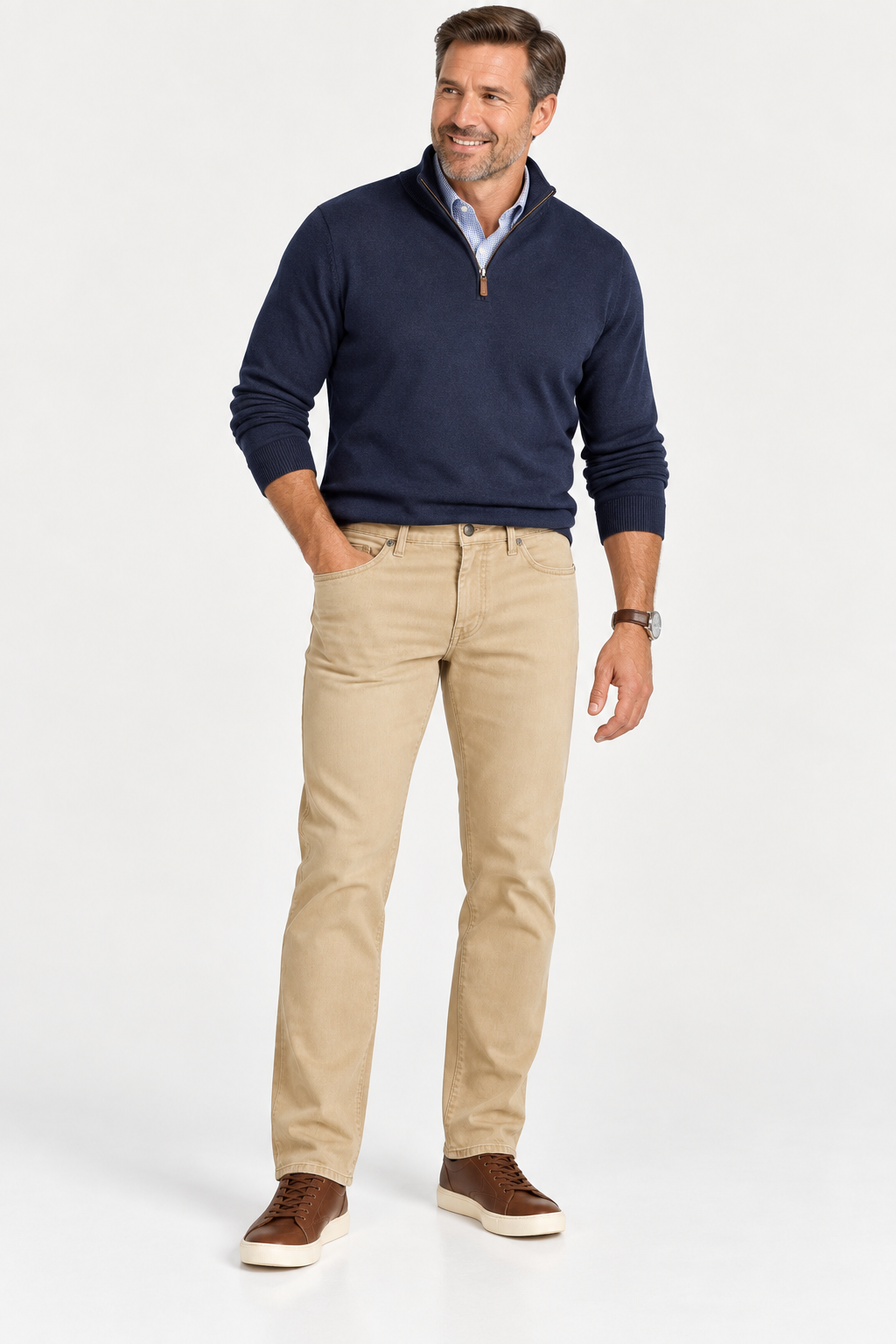A man wearing a blue quarter-zip sweater over a light blue button-down shirt, Alberto Pipe 1984 Stretch Denim khaki pants, and brown sneakers.