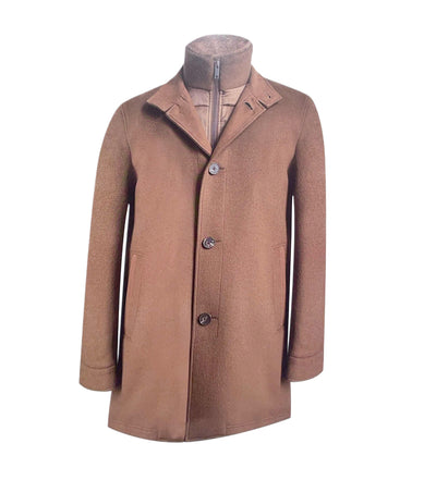 The Paul Betenly Dino Travel Coat is a classic brown wool men’s overcoat with three buttons, side pockets, a high collar, and an inner zipper layer—ideal for travel.