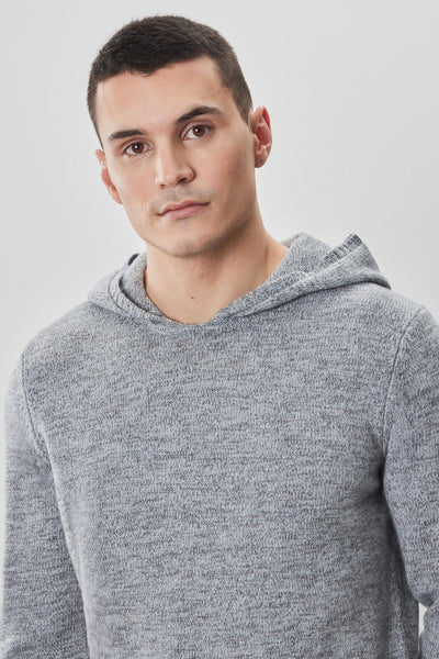 A man with short dark hair wears a light gray Robert Barakett Wildman Sweater, standing against a plain white background and looking at the camera with a neutral expression.