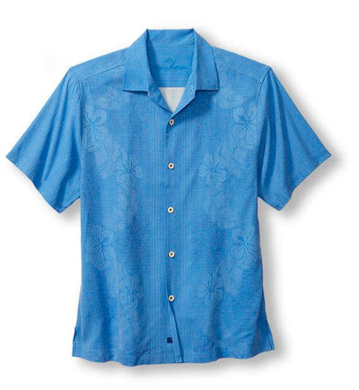 The Tommy Bahama Bali Border Big & Tall is a short-sleeved, button-up blue shirt with subtle floral patterns and a spread collar, crafted from breathable Cotton Lawn and proudly made in Hawai'i. Brand: Tommy Bahama. Displayed against a white background.
