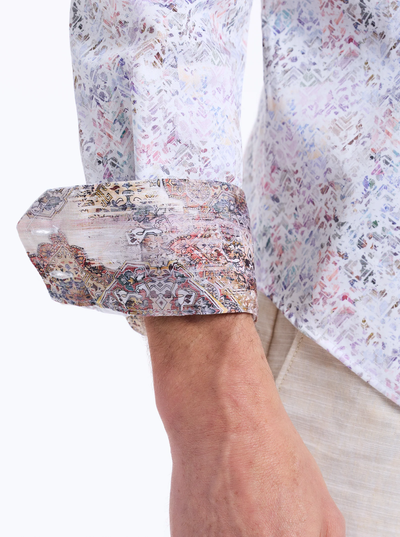 A person wears the Robert Graham LiverPool Long Sleeve Shirt (Big & Tall), featuring a patterned design with the cuff turned up to reveal a contrasting detailed print inside, signature to the Robert Graham brand.