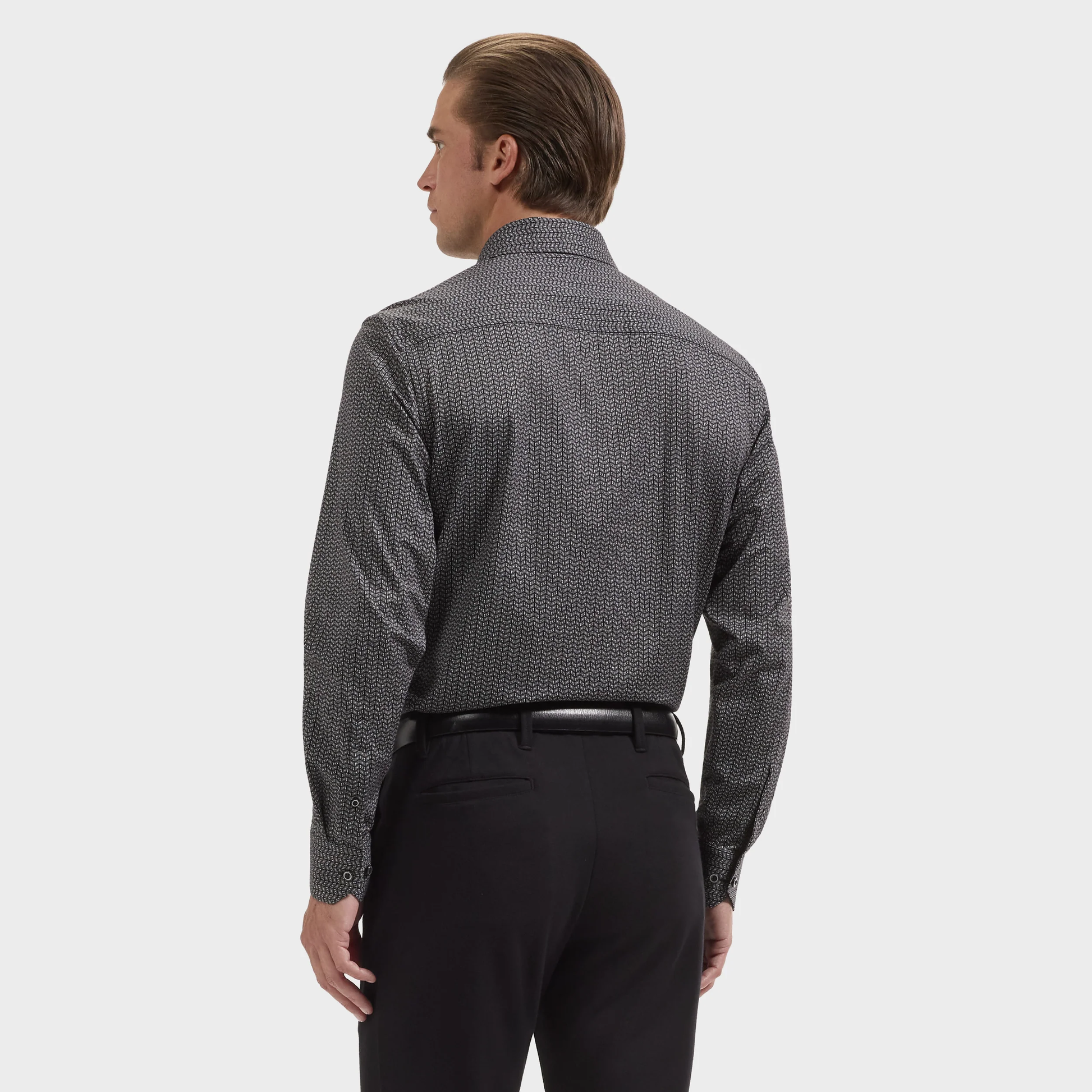A man facing away, wearing the Bugatchi James Chevron Sport Shirt (style KF9008K60) and black pants against a plain light background.