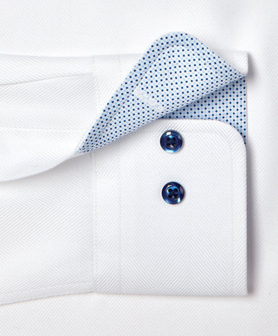 Close-up of the David Donahue Contrast Herringbone Solid Dress Shirt TBMS13100 cuff with two blue buttons and contrasting inner lining with a small blue dot pattern.
