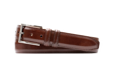 The Martin Dingman Samuel Coachman Leather Belt features classic styling in brown Italian burnished kipskin with a silver buckle, shown against a white background.