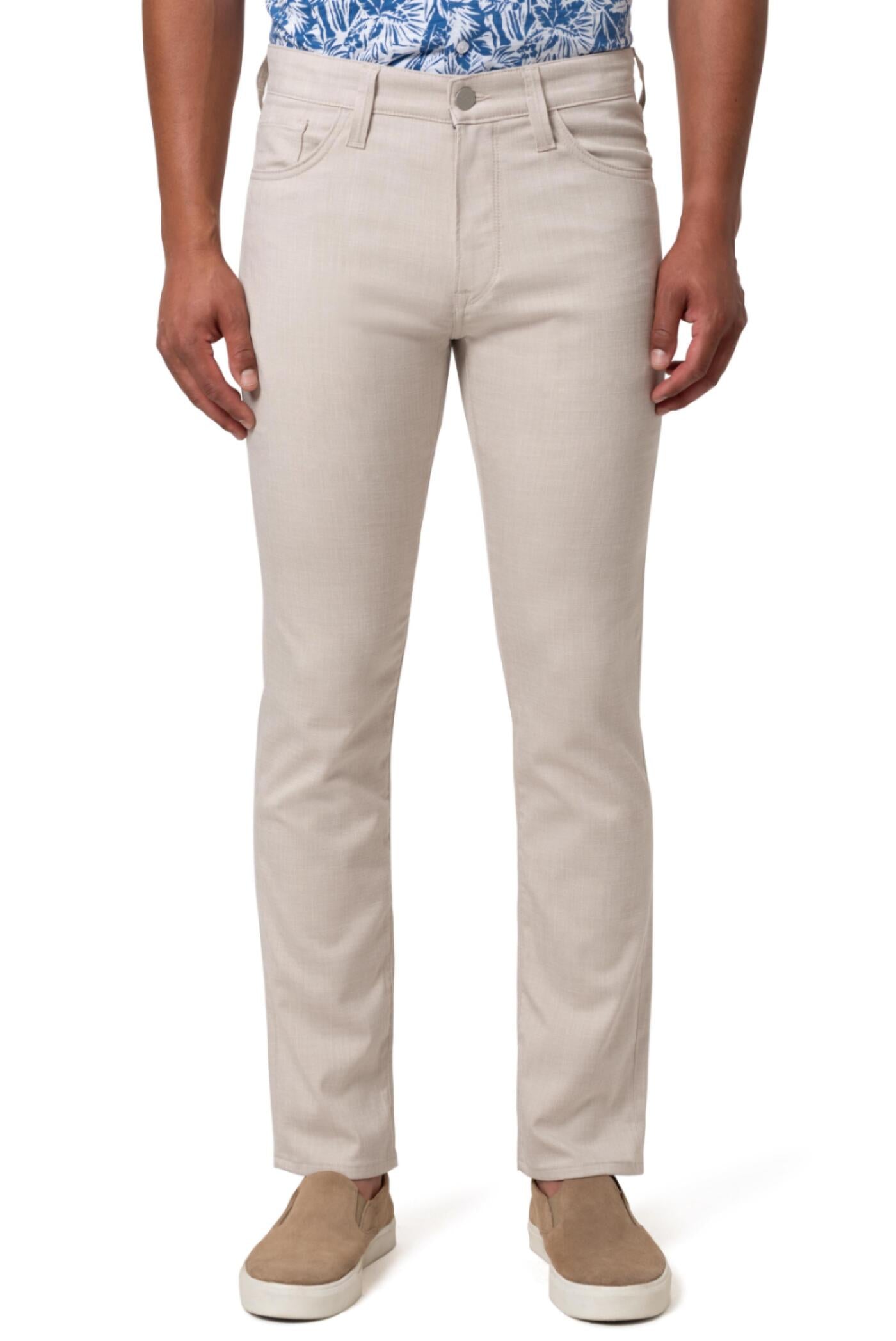 A person wearing 34 Heritage Charisma Cream Cross Twill Big & Tall pants and a blue and white floral shirt with tan slip-on shoes, standing against a white background.