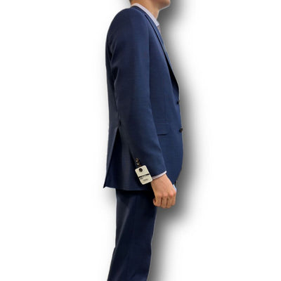 A man in a tailored fit Jack Victor Sport Coat 161150 Big and Tall stands in profile with the sleeve tag still attached, set against a plain white background.