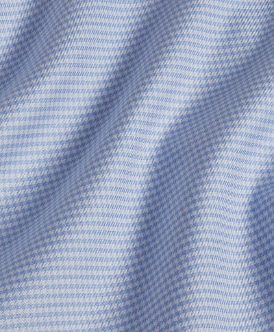 Close-up of David Donahue Twill Check TBSP10800 dress shirt fabric in blue and white, featuring a houndstooth pattern with visible folds and soft lighting.