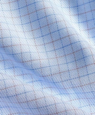 Close-up of the David Donahue Twill Check Dress Shirt TBSP12809489 fabric featuring a light blue and white grid pattern with thin brown and blue lines, showing visible folds.