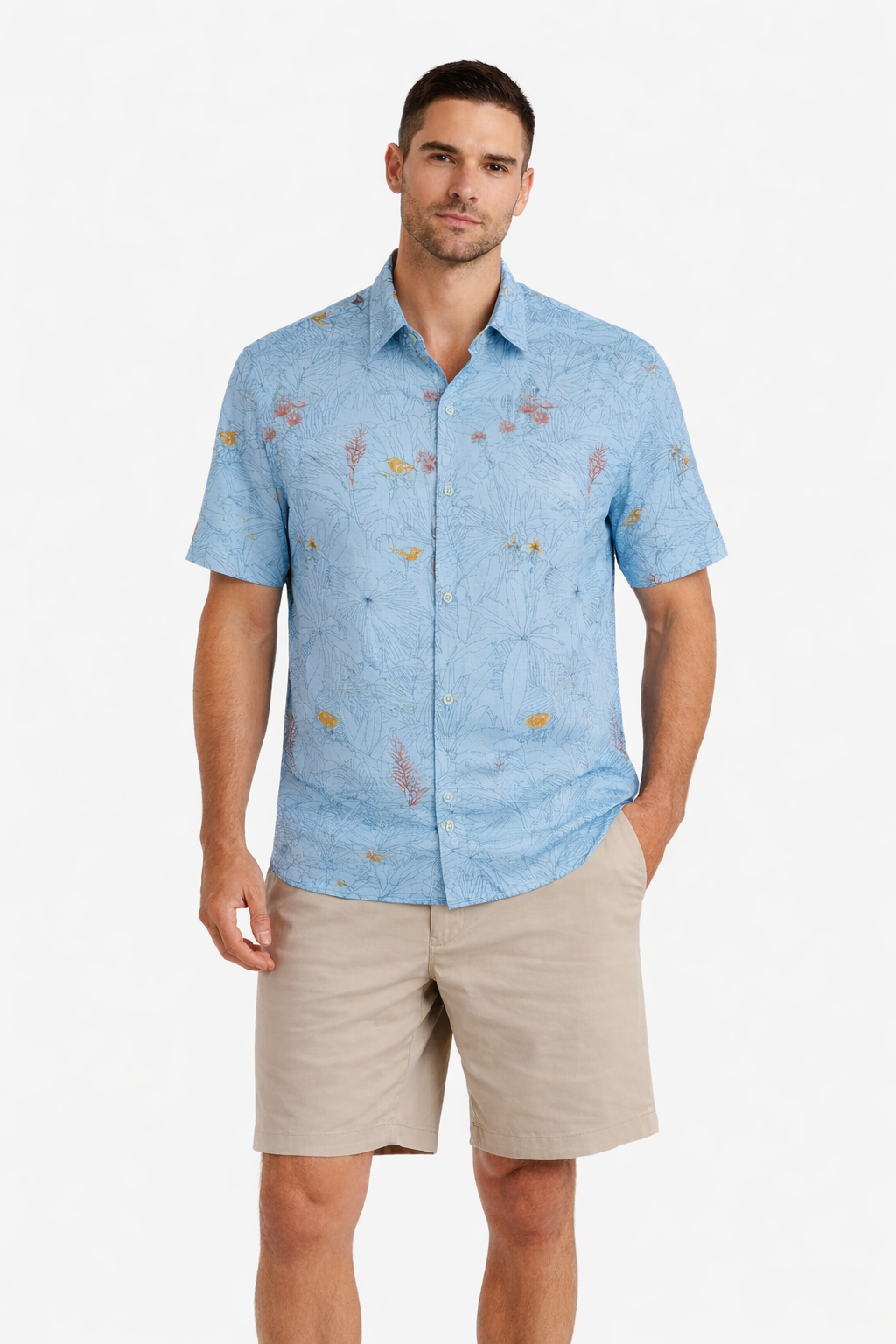 A man models the Tori Richard Printed Cotton Manu Garden Shirt 1956M0354, a light blue short-sleeve button-up with a subtle floral pattern, paired with beige shorts against a plain white background.