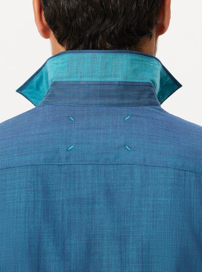 A person shown from behind wears the Robert Graham Kerrington Woven Shirt Big & Tall, featuring a blue chambray fabric with a popped collar that reveals a contrasting turquoise inner lining and visible stitching. The textured weave adds visual interest to this signature Robert Graham piece.