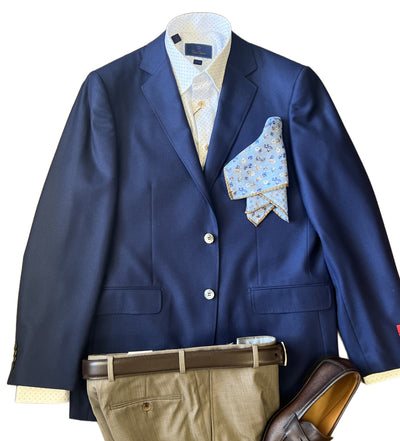 The Byron Luxe Sport Coat 8011 by Byron, in navy Italian wool, is styled with a light blue dress shirt, beige pants, brown belt and loafers, plus a blue patterned pocket square—all displayed flat on a white background.