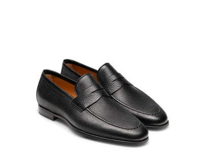The Magnanni Diezma II by Magnanni features black calfskin leather with a textured finish, low heels, and a minimalist design—ideal as a comfortable dress shoe for any occasion.