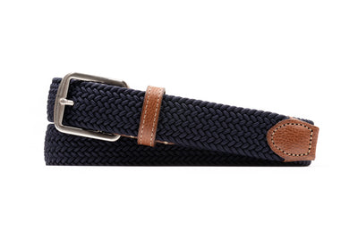 The Martin Dingman Newport Braided Elastic Belt features navy blue elastic, a silver buckle, brown leather accents, and comes neatly coiled for a polished appearance.