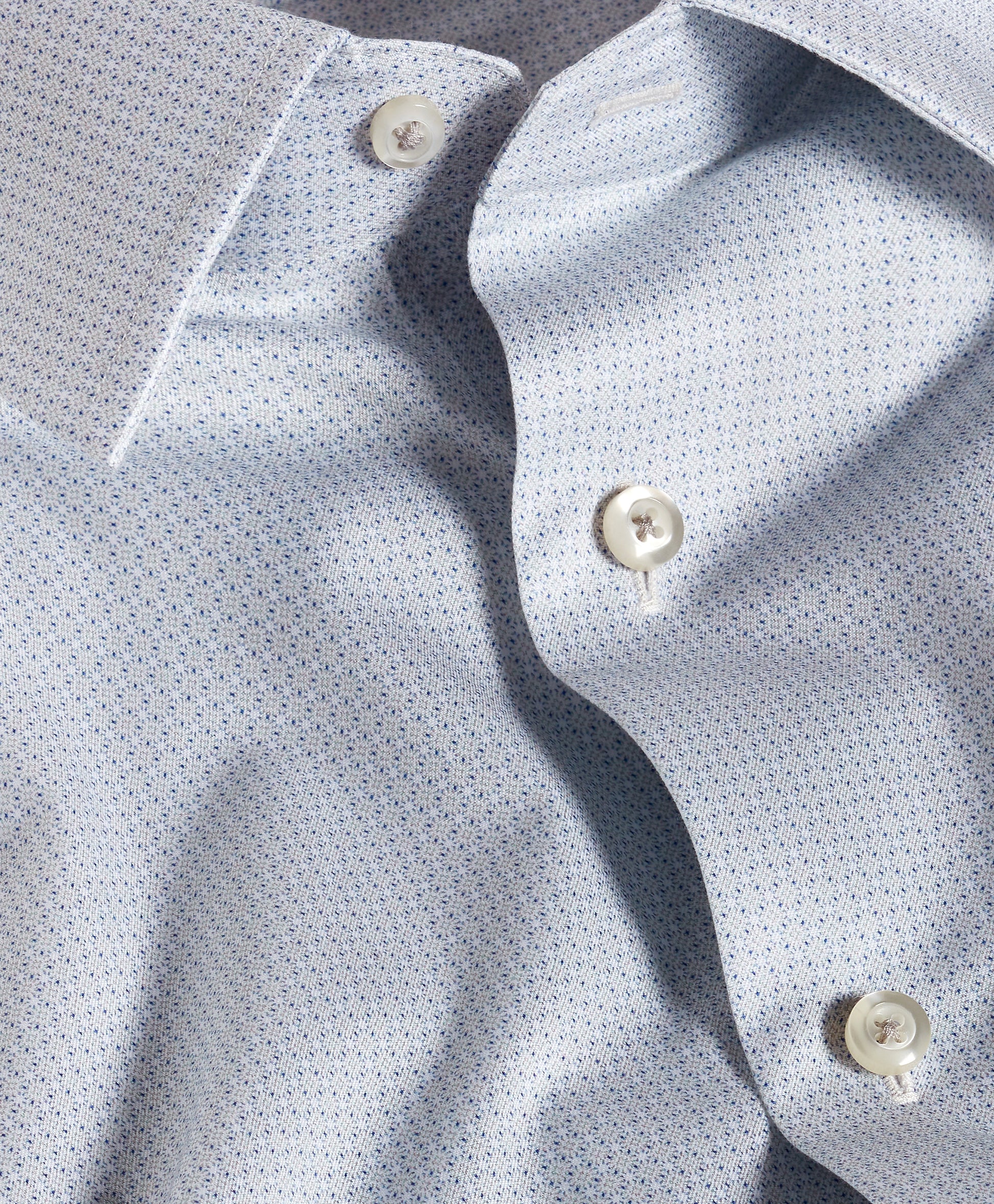Close-up of the David Donahue Micro Geometric Print Dress Shirt (TBSP13203) in light blue, featuring a fine micro geometric pattern, white buttons, and a spread collar.