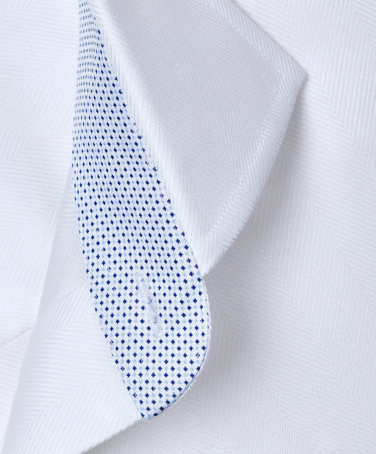 Close-up of the David Donahue Contrast Herringbone Solid Dress Shirt TBMS13100 collar with a blue dotted contrasting inner lining.