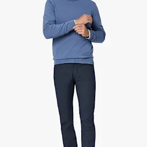 A person wearing a blue long-sleeved sweater over a white collared shirt and 34 Heritage Courage Coolmax straight leg dress pants.