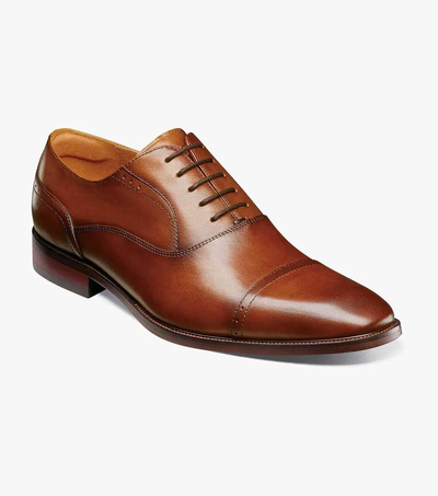 The Florsheim Sorrento Cap Toe Oxford by Florsheim is shown on a white background. This brown leather dress shoe features classic laces, a cap toe, and a low heel. Designed for both style and comfort, the Sorrento Cap Toe Oxford includes a cushioned footbed to provide lasting support throughout the day.