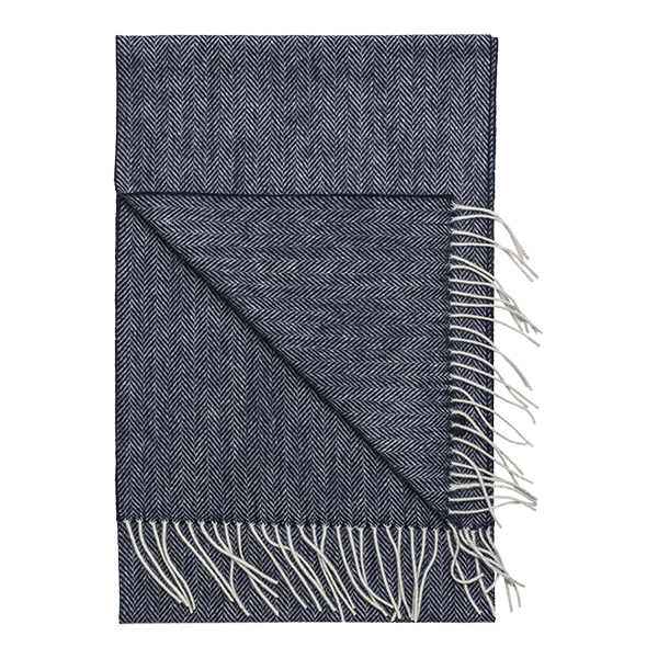 The Amanda Christensen Herringbone Scarf 44017 features a navy blue and white herringbone pattern with fringed edges, offering timeless style inspired by classic men's accessories.
