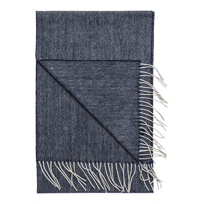 The Amanda Christensen Herringbone Scarf 44017 features a navy blue and white herringbone pattern with fringed edges, offering timeless style inspired by classic men's accessories.