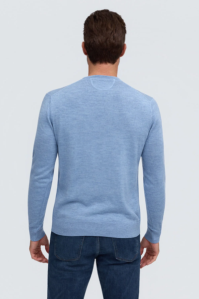 Back view of a person wearing a light blue Raffi Merino Classic Crew Neck Sweater - The Alfie - HWC19392 and blue jeans.