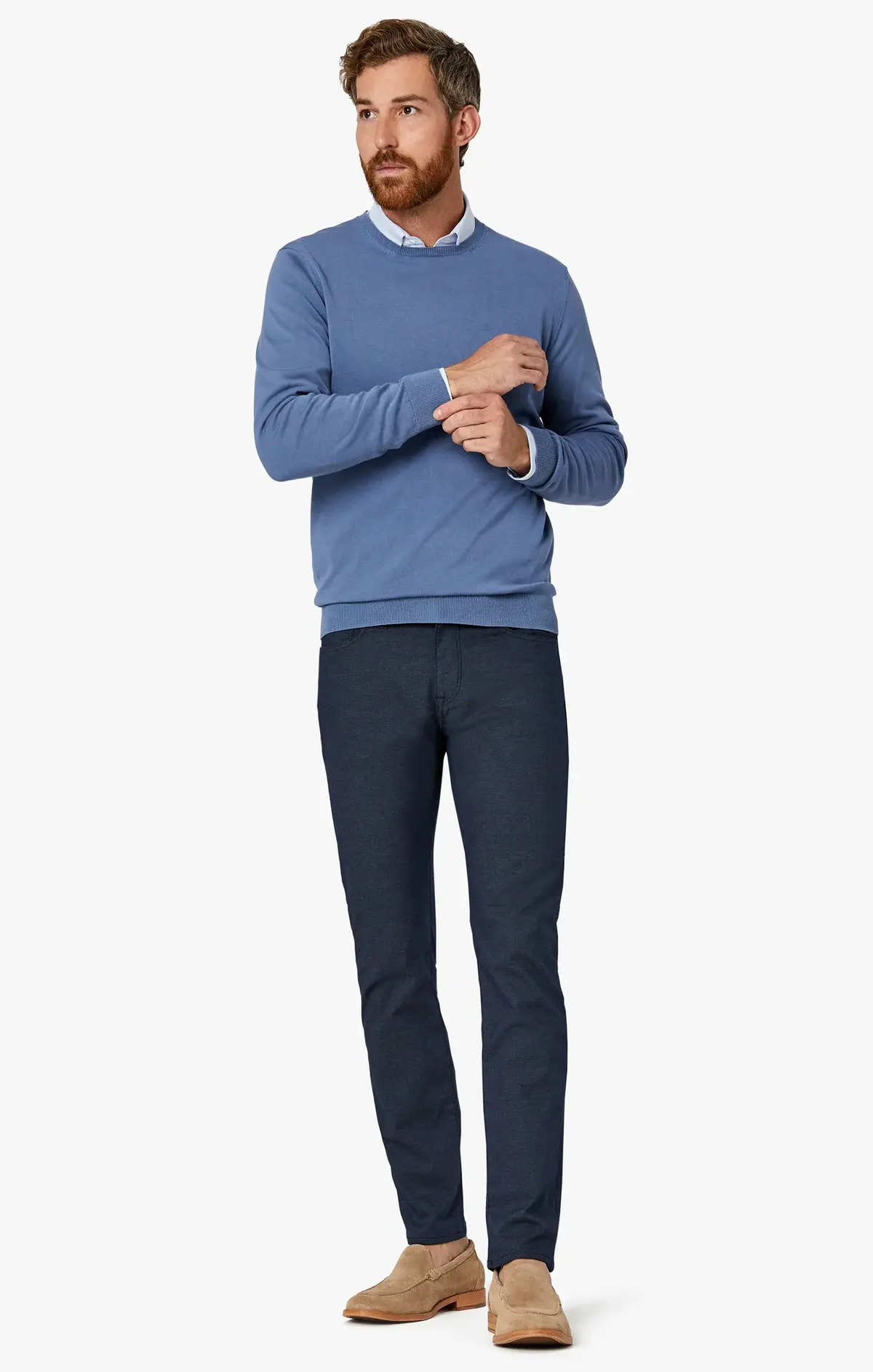 A man wearing a light blue crewneck sweater over a button-down shirt, 34 Heritage Courage Coolmax straight leg dress pants, and tan loafers.