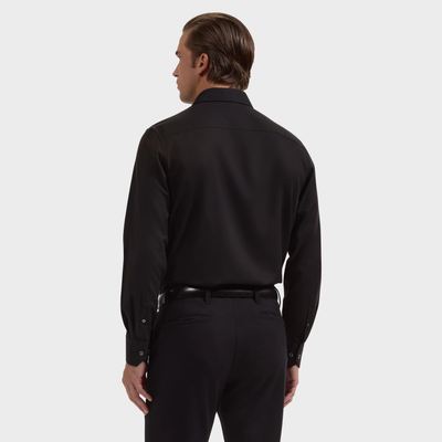 A person is shown from the back against a plain white background wearing the Bugatchi Julian Tonal Geometric Jacquard Shirt KS4001L3S in black, paired with black pants.