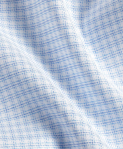 Close-up of the David Donahue OP White & Blue Check Dress Shirt (TBSP12816135), crafted from soft Pima cotton with a crisscross grid pattern, showcasing visible folds and texture.