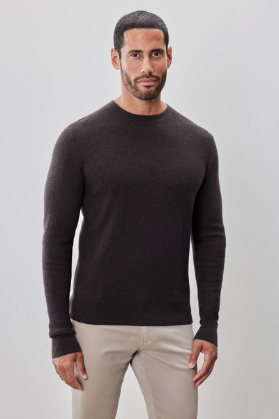 A man with short dark hair and a trimmed beard wears the Robert Barakett Watertown Sweater by Robert Barakett with light-colored pants, standing against a plain light background.
