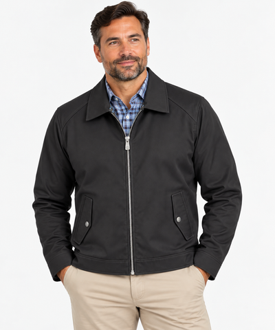 Man wearing a Hart Schaffner Marx Felix Commuter Jacket 6214 over a blue plaid shirt and beige pants, standing with hands in pockets against a plain background.