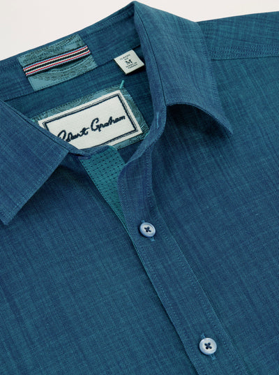 Close-up of the Robert Graham Kerrington Woven Shirt Big & Tall, featuring a blue textured weave, pointed collar, two matching blue buttons, and a visible Robert Graham label inside the collar. This stylish shirt from the Robert Graham Big & Tall collection highlights the refined details of a two-tone chambray design.