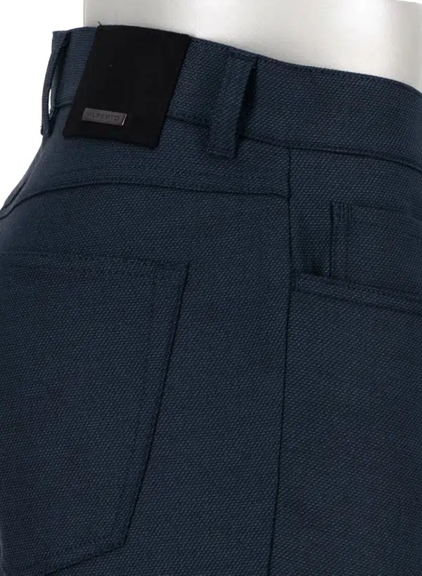 Close-up of the back and side pocket area of the Alberto Pipe Melange Birdseye Pant 1638 in dark blue, highlighting the pocket stitching, belt loops, and a black rectangular label on the waistband.