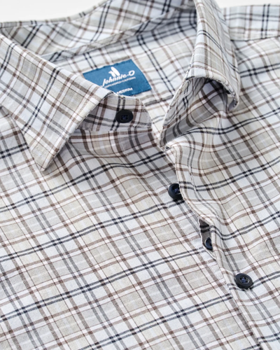 Close-up of a buttoned, long-sleeve men’s flannel shirt from Johnnie-O, featuring a beige, brown, and black plaid pattern and a visible blue label inside the collar. The Johnnie-O Tahoe Plaid Flannel Shirt Big & Tall offers a classic yet modern look.