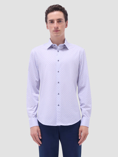A man models the Bugatchi LS Jules GF9306K65 Dusty Pink shirt with dark trousers, facing the camera against a light gray background, showcasing Bugatchi’s refined Italian-inspired style.