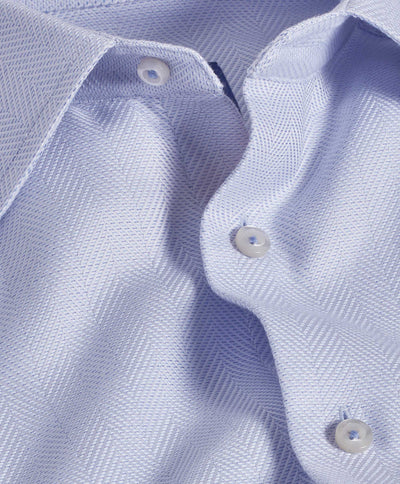 Close-up of the David Donahue TBSP10013 dress shirt in light blue Pima cotton, featuring a spread collar, button front, and subtle herringbone weave detailing.