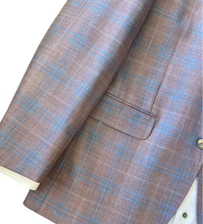Close-up of the Byron Contemporary Sport Coat 6674A by Byron, featuring a mauve blue plaid Italian fabric, with a flap pocket and button detail visible against a light background.