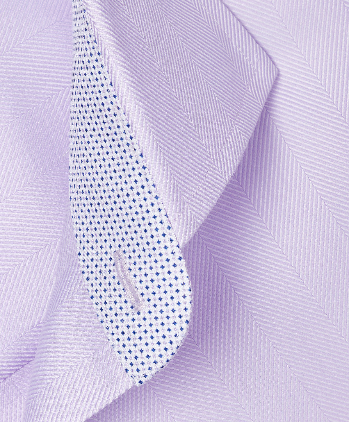 Close-up of a folded David Donahue Contrast Herringbone Solid Dress Shirt TBMS13100 collar with blue dot inner lining.