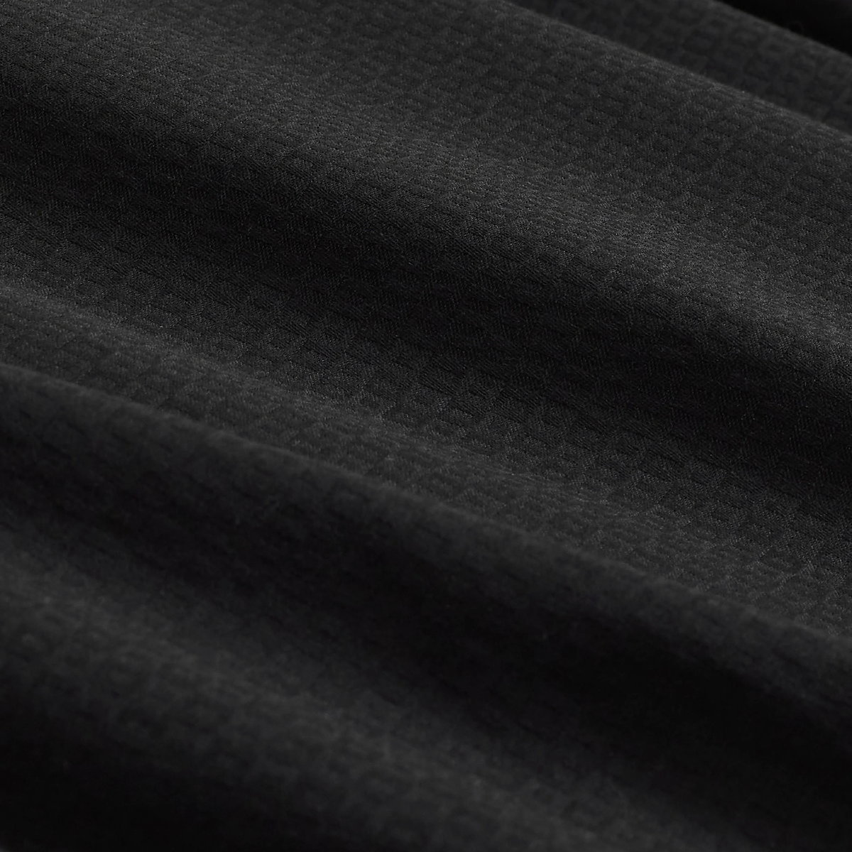 Close-up of the textured, wrinkle-resistant black fabric with a subtle grid pattern and gentle folds—perfect for the Bugatchi Julian Tonal Geometric Jacquard Shirt KS4001L3S by Bugatchi.
