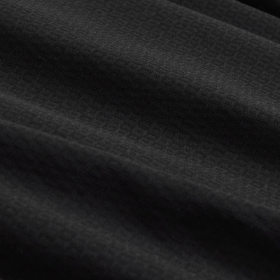 Close-up of the textured, wrinkle-resistant black fabric with a subtle grid pattern and gentle folds—perfect for the Bugatchi Julian Tonal Geometric Jacquard Shirt KS4001L3S by Bugatchi.