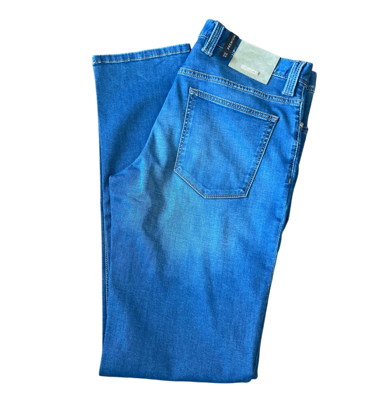 The Alberto Pipe Denim 1367 by Alberto is a pair of folded regular fit jeans in lightweight denim, featuring a visible back pocket and waistband tag, isolated on a white background.