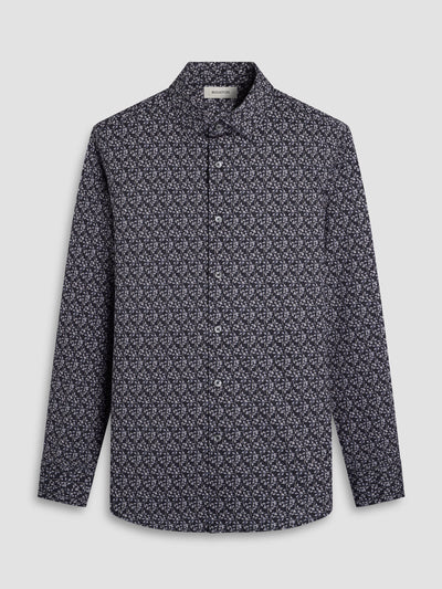 The Bugatchi James Leaf Print Sport Shirt HF9221K60 features long sleeves, a button-up front, and a subtle white leaf print on a dark background. This breathable cotton shirt from Bugatchi combines comfort and style. Displayed on a light gray backdrop.