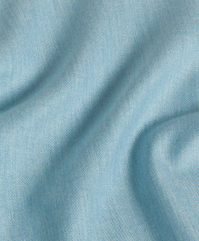 Close-up of the David Donahue Herringbone Sport Shirt CBSM10100 fabric in light blue Pima cotton, featuring a subtle herringbone pattern and soft folds.