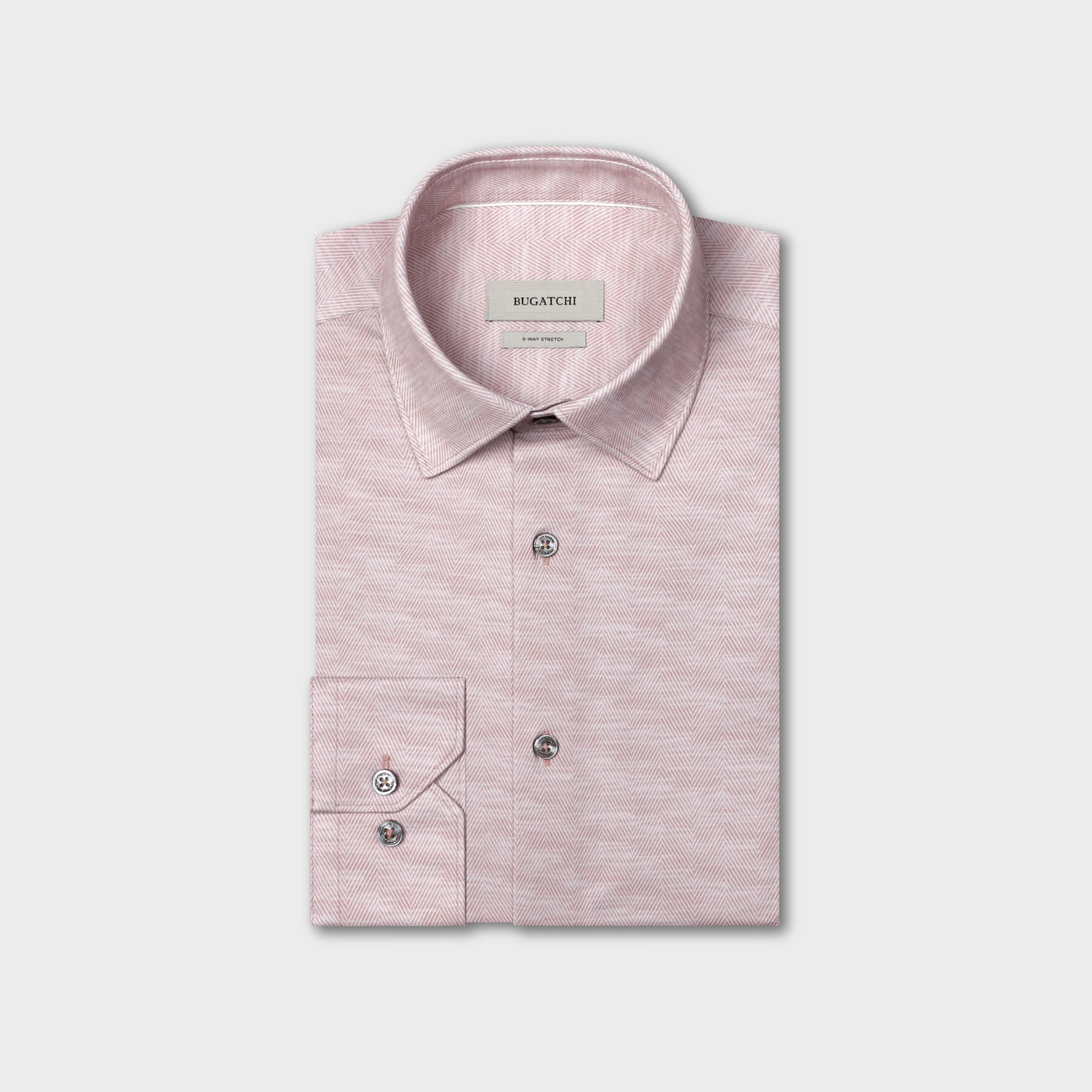 A folded light pink Bugatchi James Herringbone Sport Shirt (KF9508K60) with a subtle herringbone pattern, buttoned collar and cuffs, crafted from wrinkle-resistant performance fabric by Bugatchi, displayed against a plain white background.