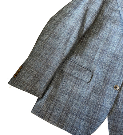 A close-up of the Jack Victor Sport Coat 1252227 by Jack Victor shows its grey windowpane pattern, buttoned cuff, flap front pocket, and a single visible button.