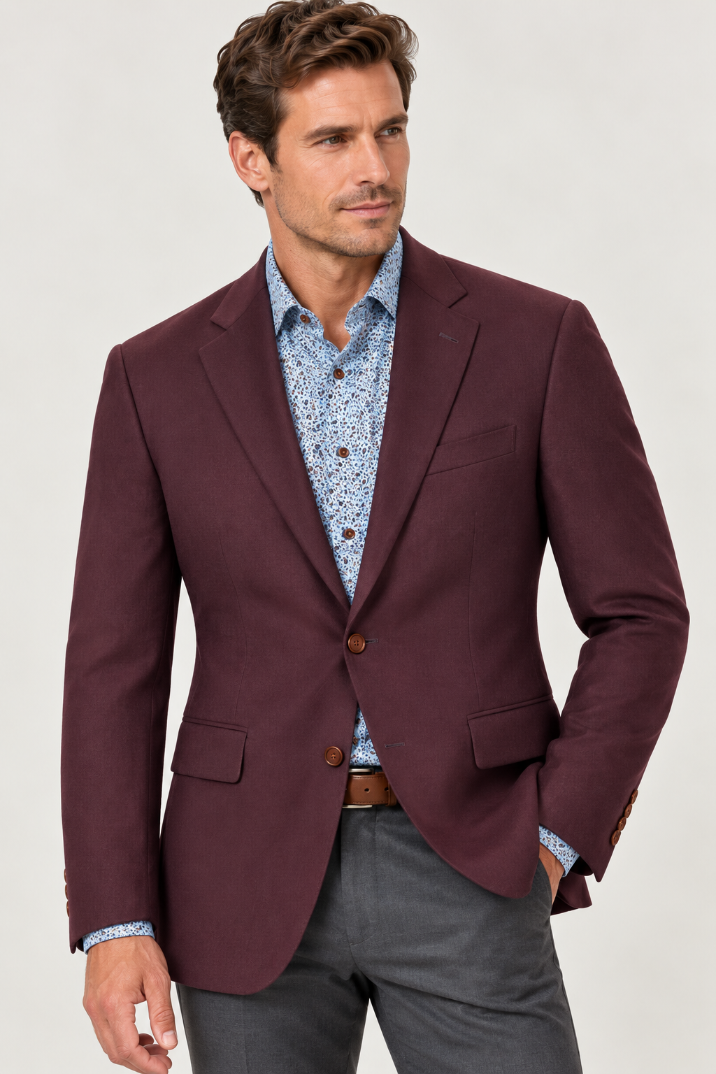 A man wears a MaxDavoli Burgundy Cashmere Blend Sport Coat MD86351 over a blue patterned button-down shirt and grey trousers.