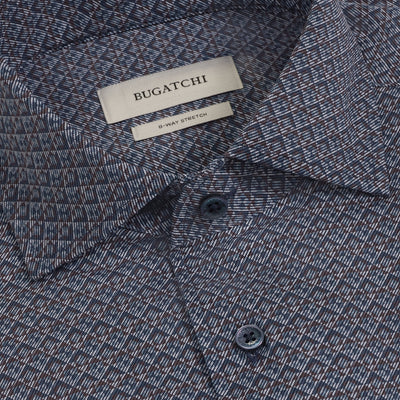 Close-up of a patterned blue Bugatchi Devon Geometric Sport Shirt (KF9431K80) featuring a visible collar, two buttons, and a label reading BUGATCHI and 8-WAY STRETCH. Crafted from wrinkle-resistant performance fabric, this shirt offers both style and comfort for any occasion.