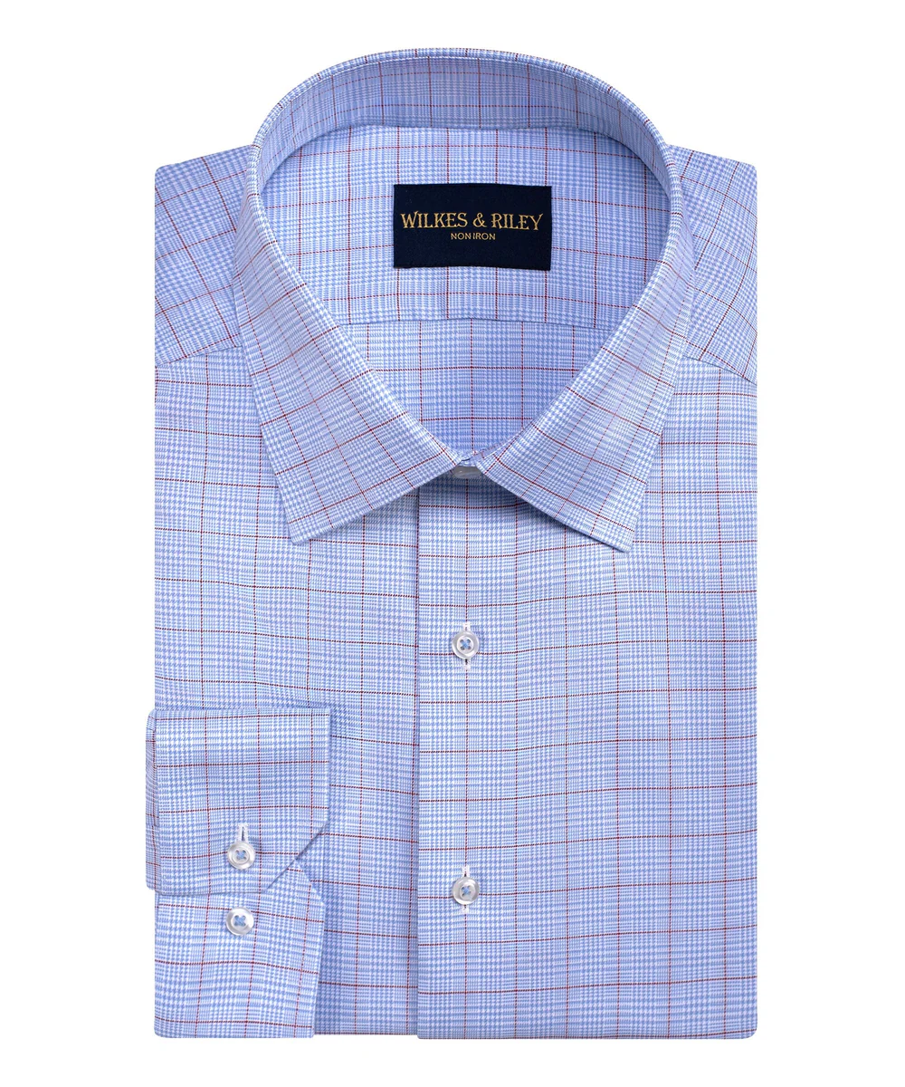 A neatly folded Wilkes & Riley Sky/Burg Plaid F5800 dress shirt with a light blue and burgundy checkered pattern, featuring the Wilkes & Riley label on the spread collar.