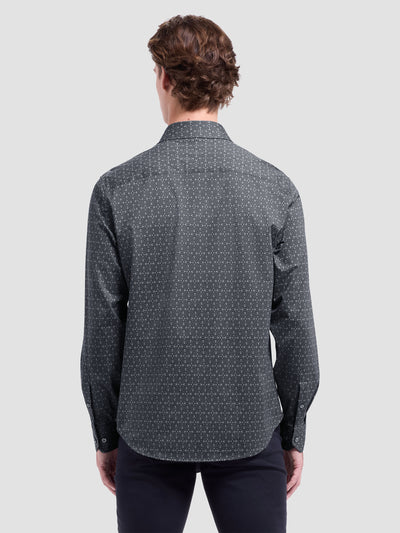 A man stands with his back to the camera, wearing a Bugatchi James Geometric Sport Shirt HF9027K60 and black pants against a plain light background.